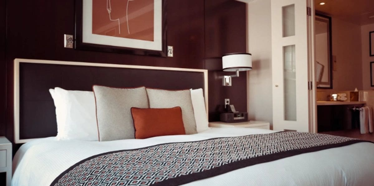 Swept Away Cleaning — a freshly made bed in a spotless, hotel-crisp bedroom