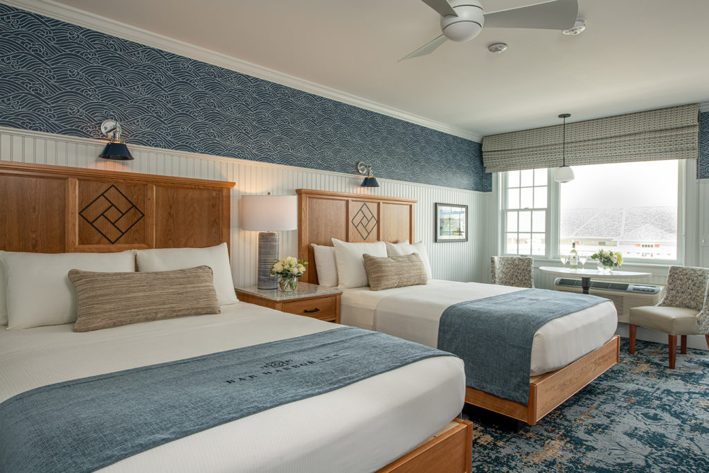 Bar Harbor Inn guest room with two beds and a window seating area